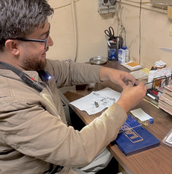 Aura Locksmith technician cutting a key at the in-store locksmith counter
